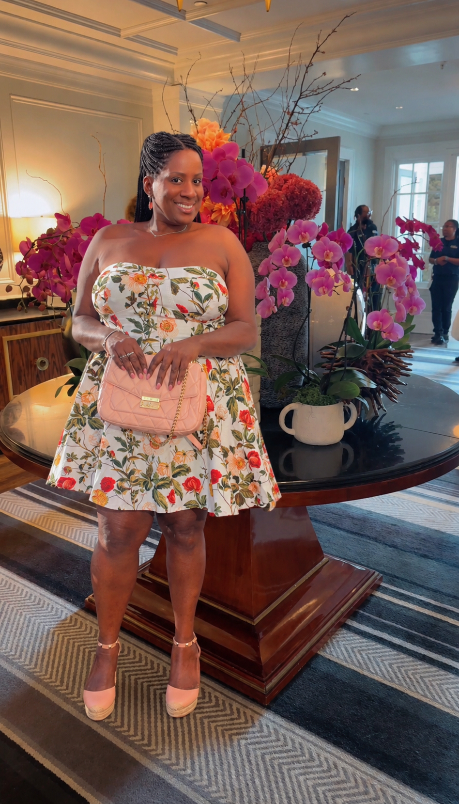 Tinzley Bradford in a floral dress at a hotel lobby